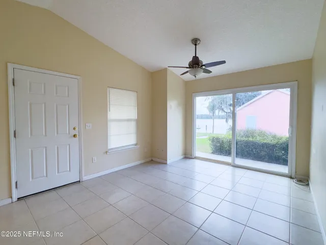 a view of an empty room with glass door