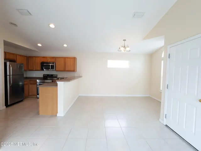 a view of a kitchen with microwave and cabinets