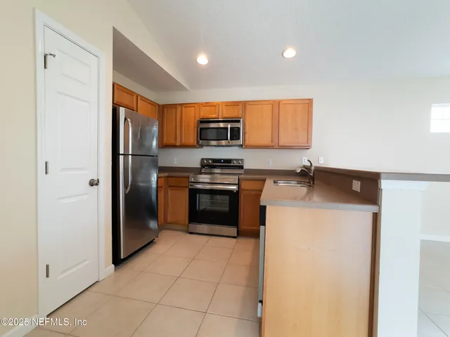 a kitchen with a refrigerator sink and stove