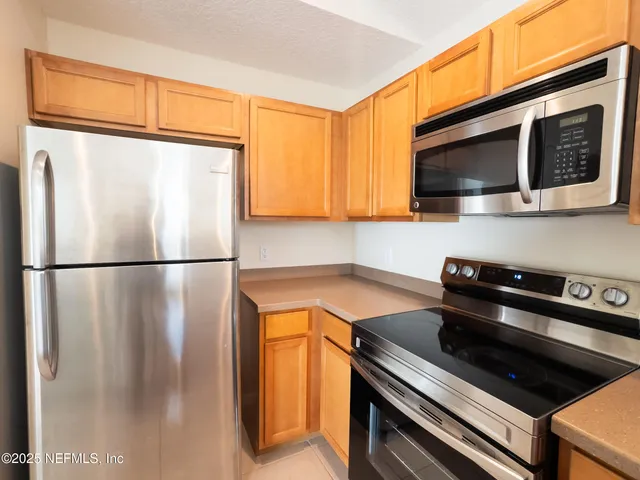 a kitchen with a refrigerator and a microwave