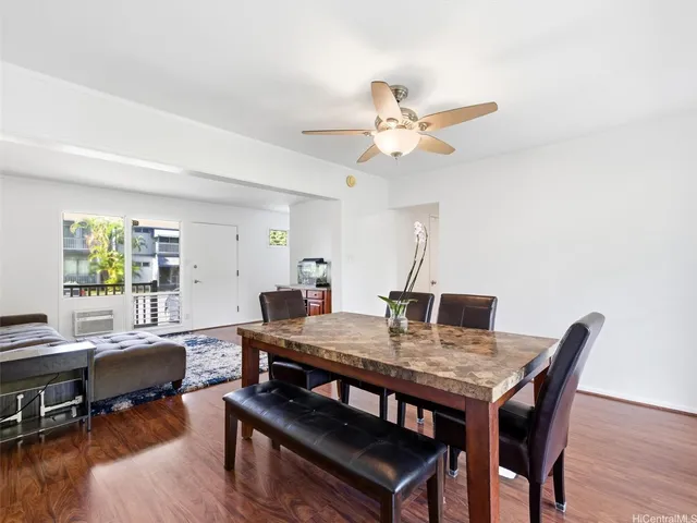 a view of a dining room with furniture and wooden floor