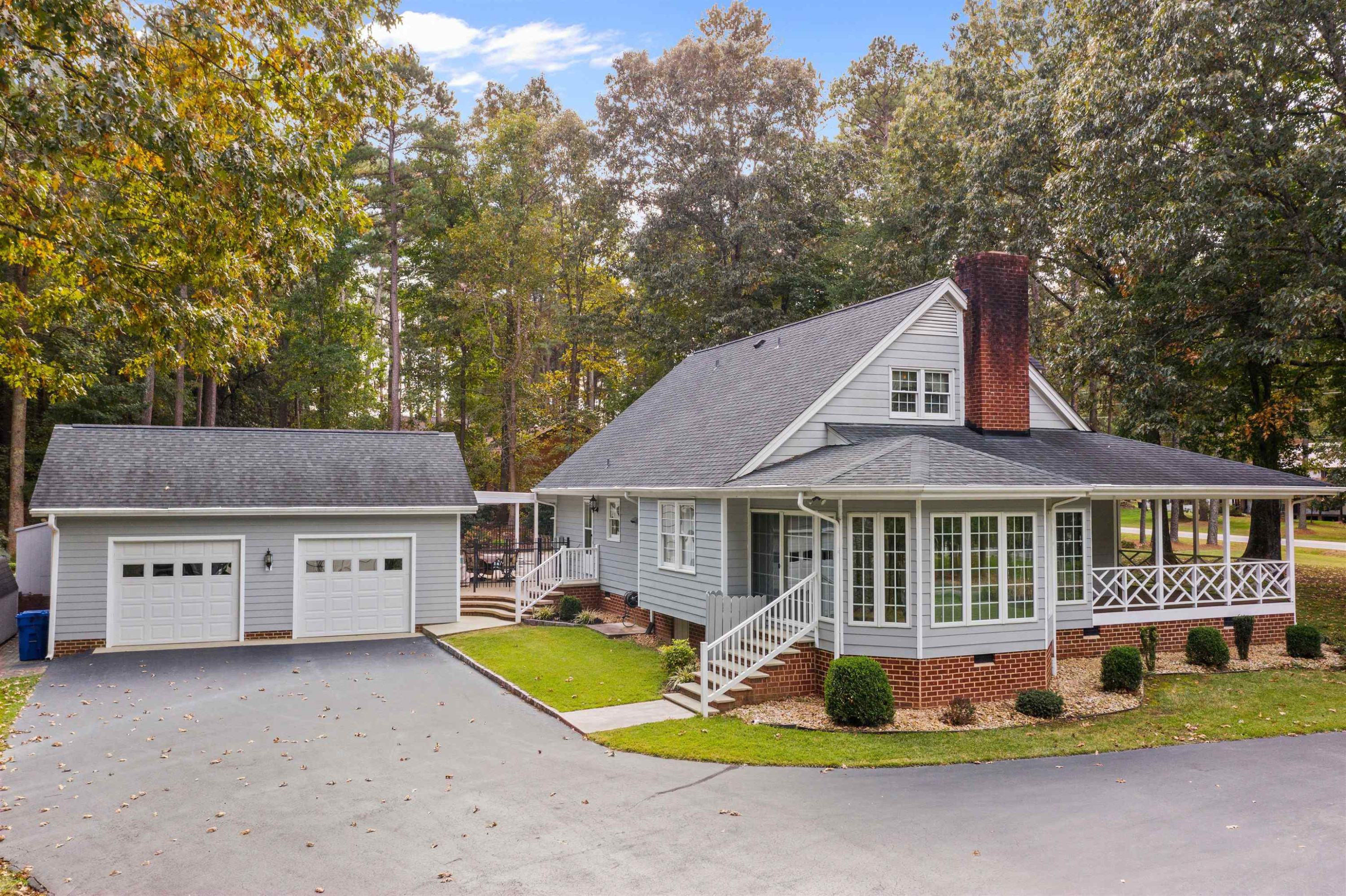 8417 Crowder Road Raleigh, NC 27603 - Photo 24 of 30 View of the back of the home with 2 car detached garage and additional parking pad. Exterior Back