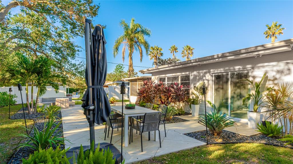6726 South Lockwood Ridge Road Sarasota, FL 34231 - Photo 34 of 36 a view of a patio with table and chairs and potted plants