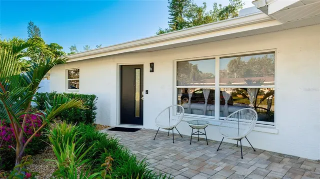 a view of a patio with table and chairs and potted plants