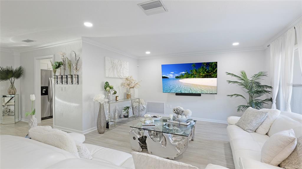 6726 South Lockwood Ridge Road Sarasota, FL 34231 - Photo 9 of 36 a living room with furniture and a flat screen tv