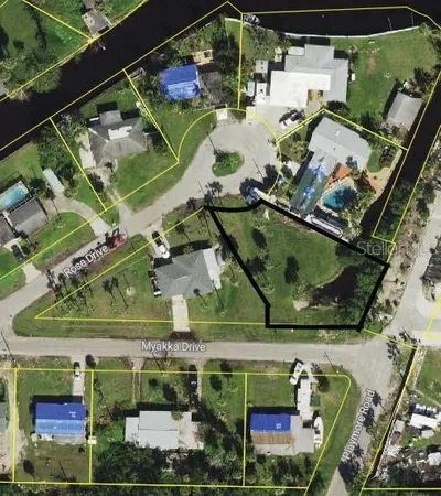 an aerial view of a tennis ground with a yard