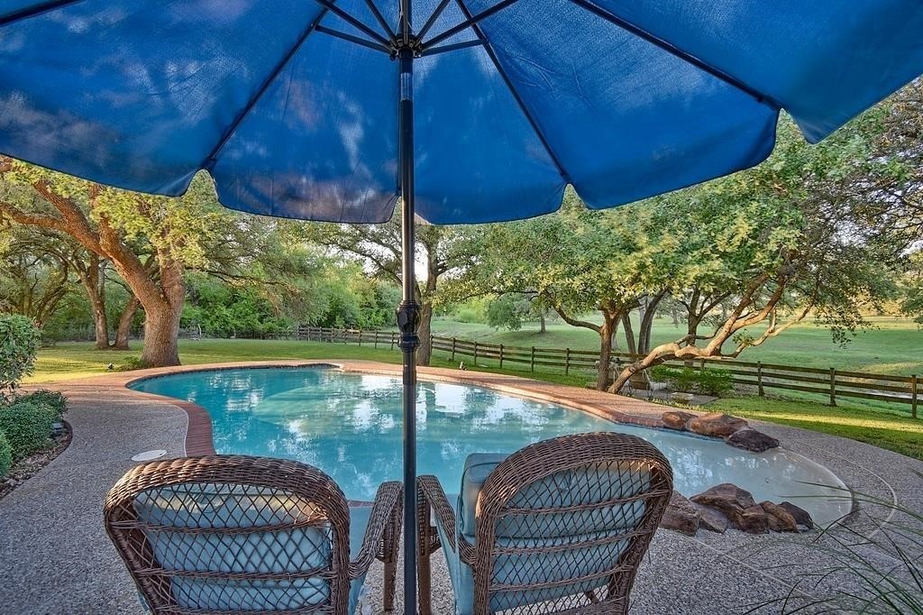 8456 Schuster Road Ledbetter, TX 78946 - Photo 9 of 49 a view of backyard with swimming pool and outdoor seating