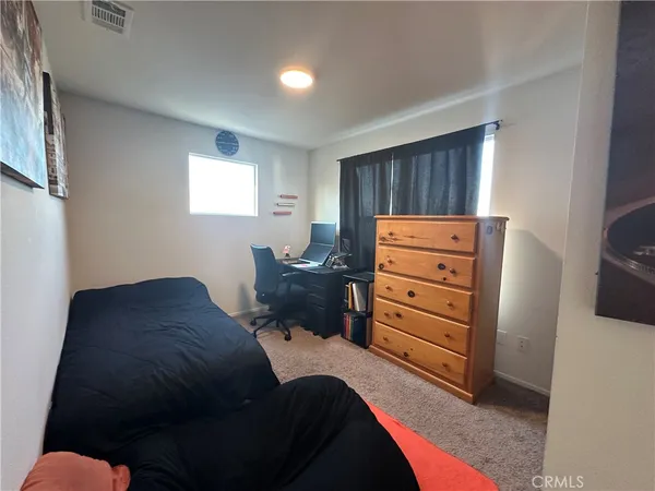 a bed room with a bed and a window