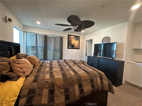 a bedroom with a bed and a large mirror