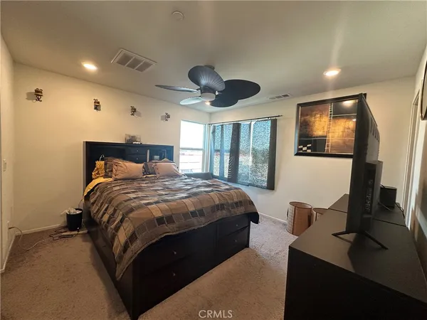 a bedroom with bed and window