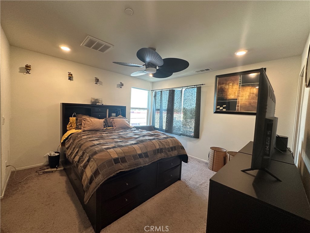 17612 Garden House Lane Bellflower, CA 90706 - Photo 15 of 31 a bedroom with bed and window