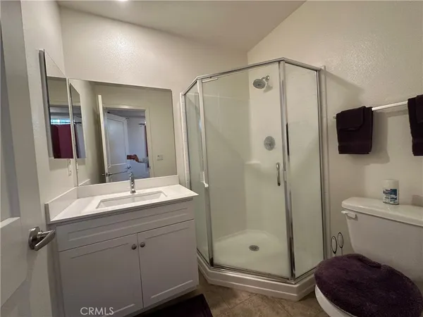 a bathroom with a double vanity sink toilet and shower