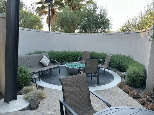 an outdoor sitting area with furniture and wooden fence