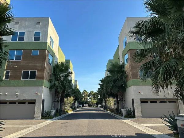 a view of multiple house with palm trees