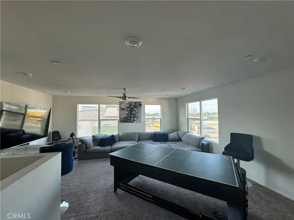 a living room with furniture window and a flat screen tv