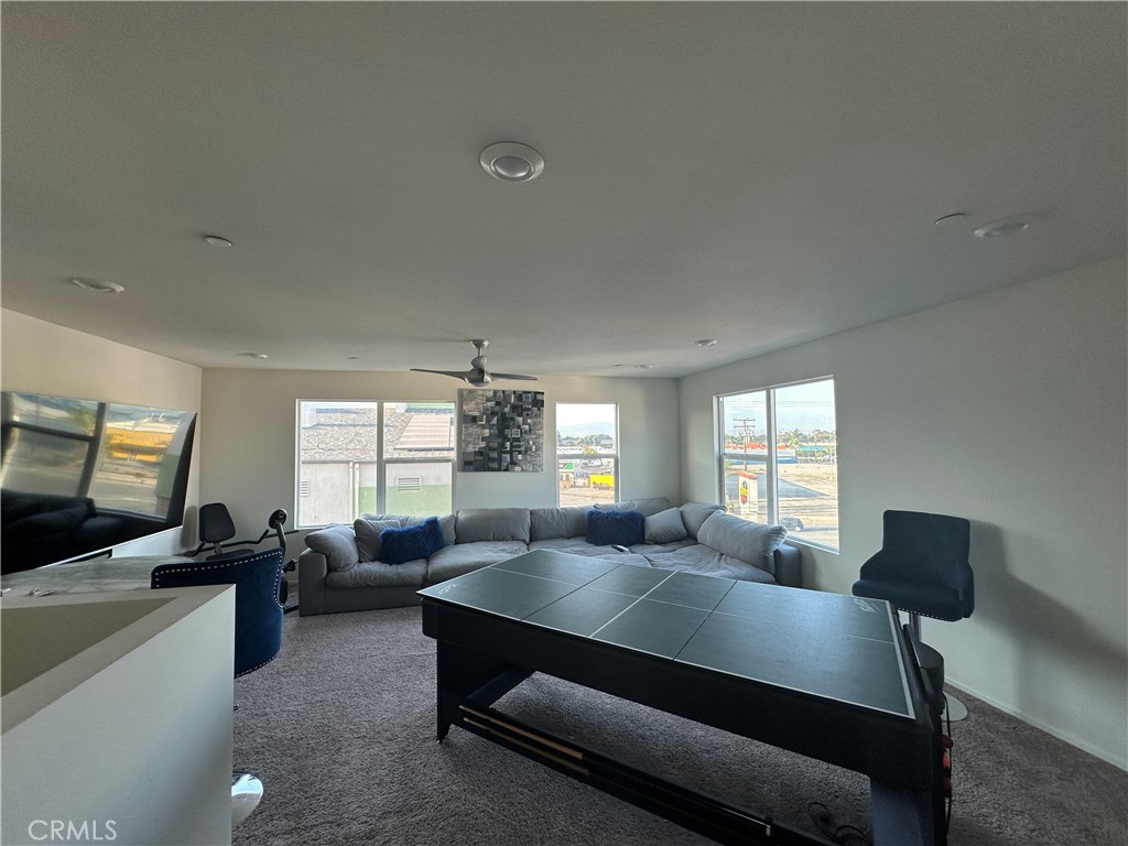 17612 Garden House Lane Bellflower, CA 90706 - Photo 7 of 31 a living room with furniture window and a flat screen tv