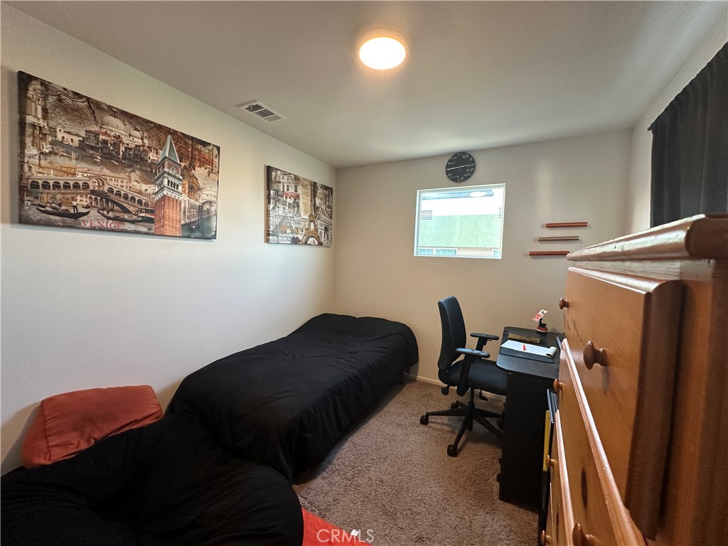 17612 Garden House Lane Bellflower, CA 90706 - Photo 10 of 31 a bedroom with a bed and a window