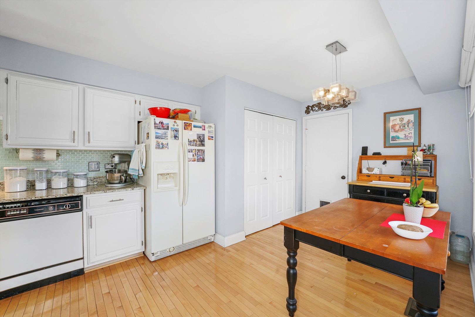 14501 Golf Road Orland Park, IL 60462 - Photo 16 of 53 a kitchen with stainless steel appliances wooden floor dining table and chair