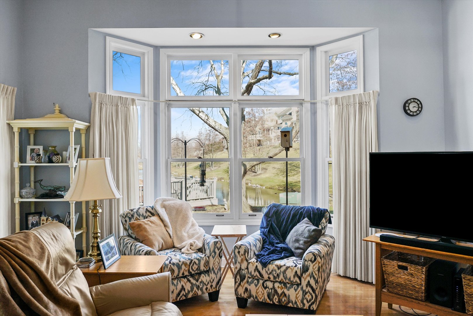14501 Golf Road Orland Park, IL 60462 - Photo 39 of 53 a living room with furniture a flat screen tv and a large window