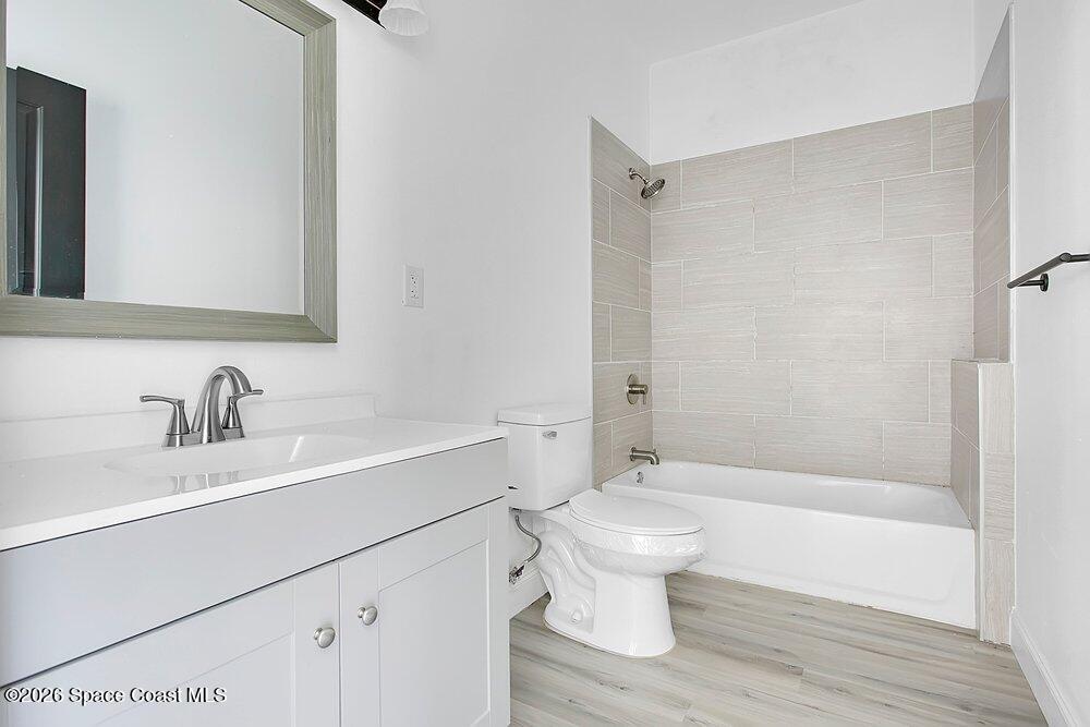 2498 Mitchell Avenue Mims, FL 32754 - Photo 14 of 31 a bathroom with a sink toilet a mirror and shower
