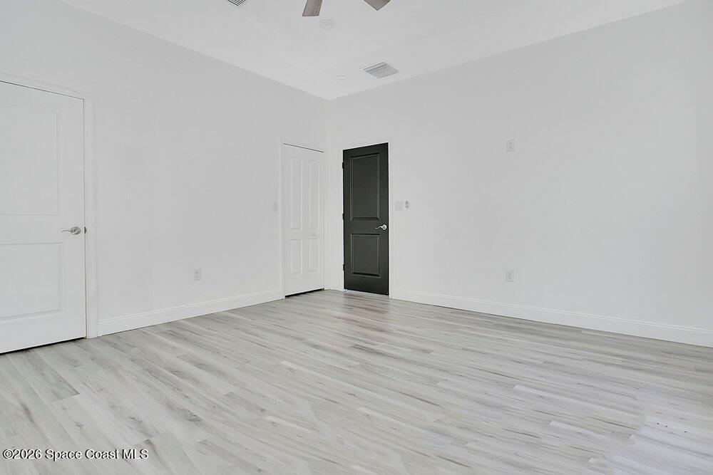2498 Mitchell Avenue Mims, FL 32754 - Photo 17 of 31 a view of an empty room with wooden floor