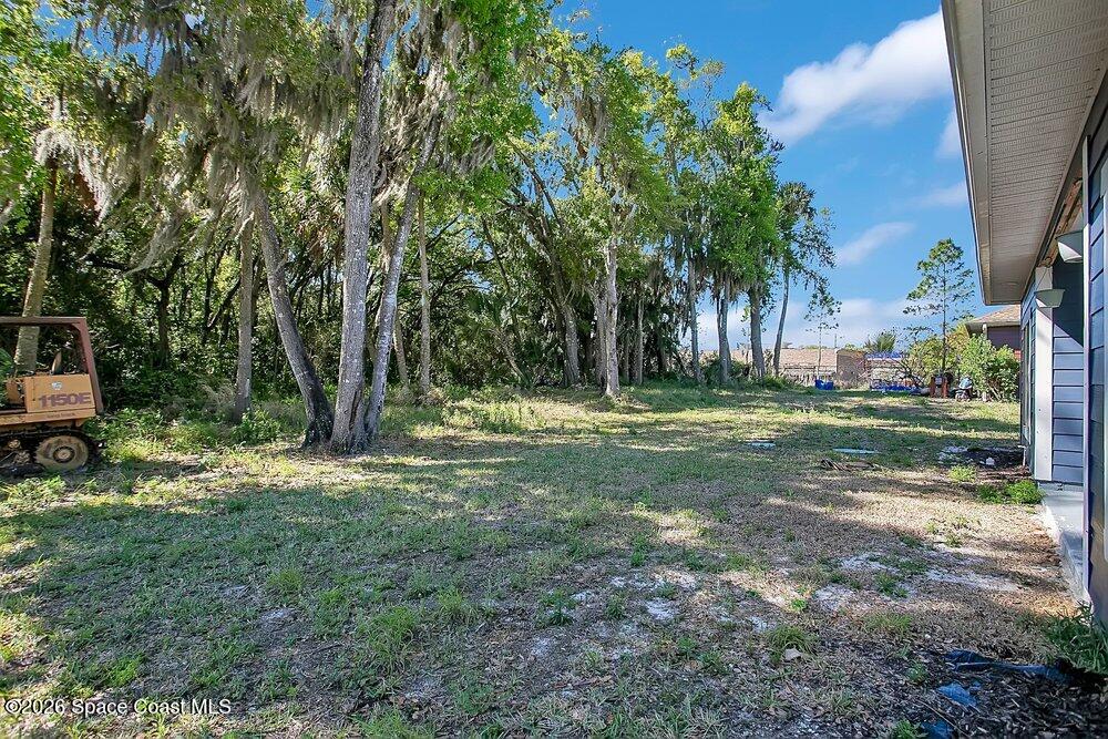 2498 Mitchell Avenue Mims, FL 32754 - Photo 21 of 31 a backyard of a house with table and chairs