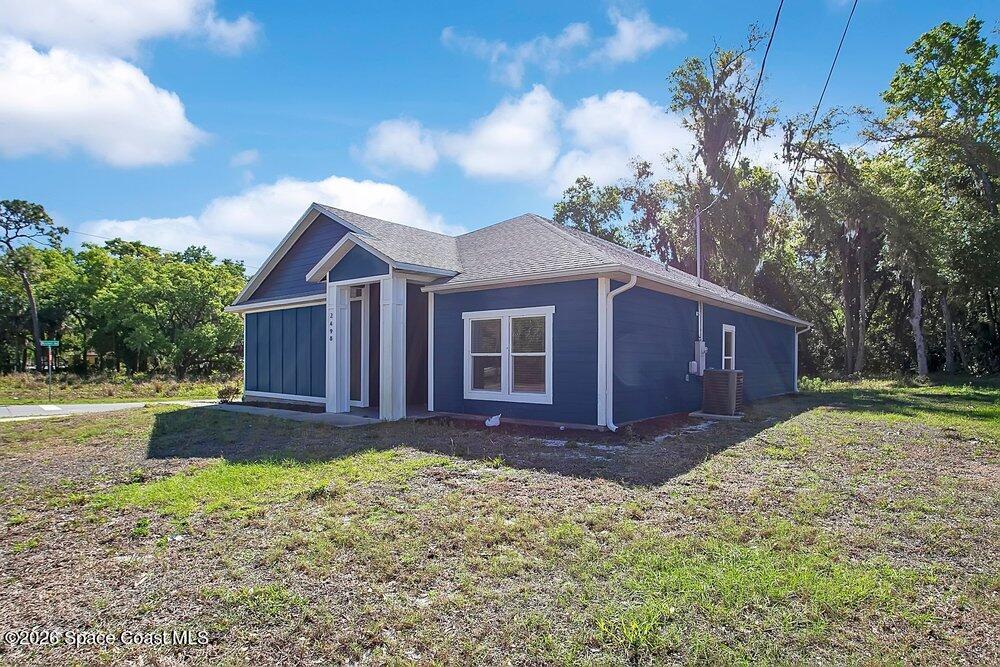 2498 Mitchell Avenue Mims, FL 32754 - Photo 4 of 31 a front view of a house with a yard and garage
