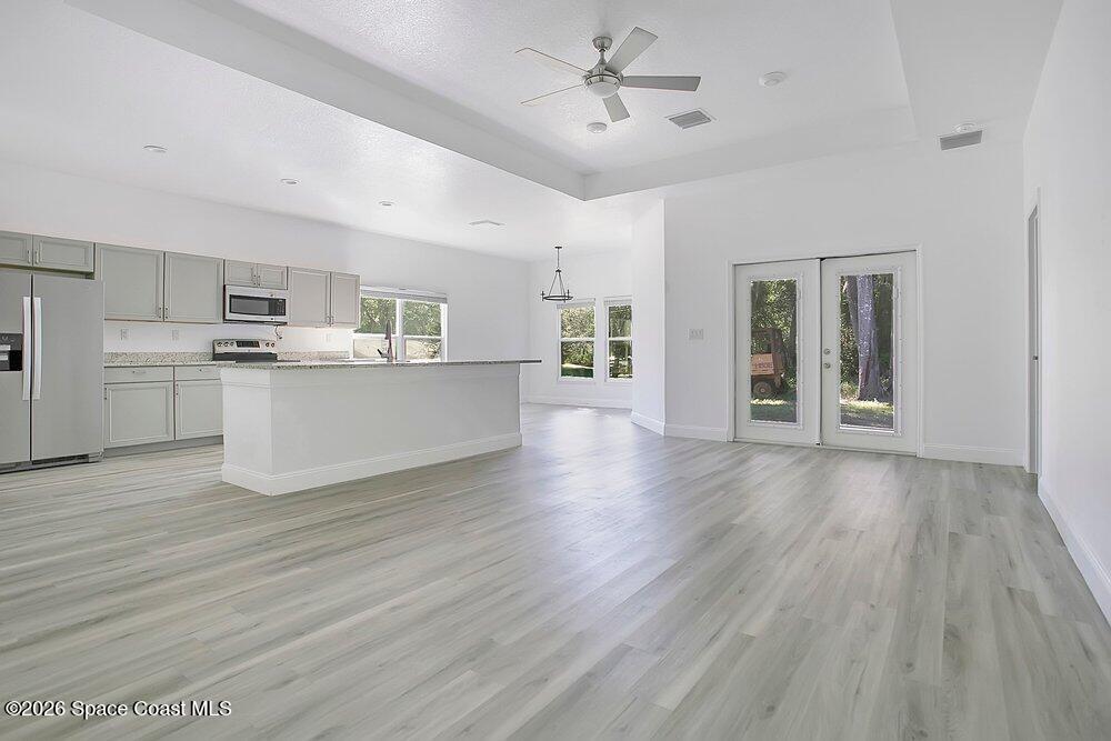 2498 Mitchell Avenue Mims, FL 32754 - Photo 5 of 31 a view of a kitchen with a sink and dishwasher a refrigerator with wooden floor