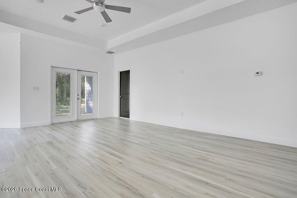 2498 Mitchell Avenue Mims, FL 32754 - Photo 6 of 31 wooden floor in an empty room with a window