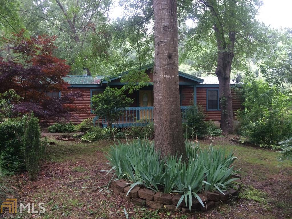 117 Giles Road Winder, GA 30680 - Photo 1 of 1 a backyard of a house with plants and large trees