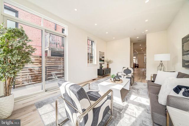 a view of a living room filled with furniture