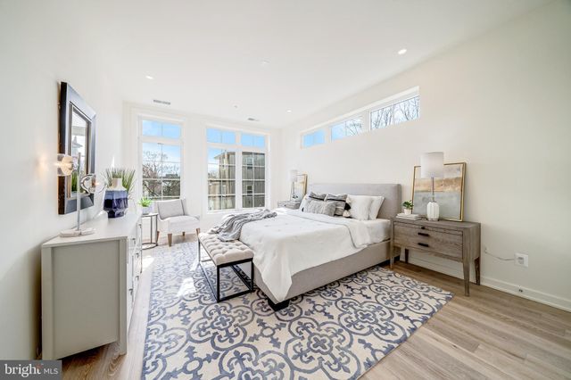 a bed room with a bed and a chair