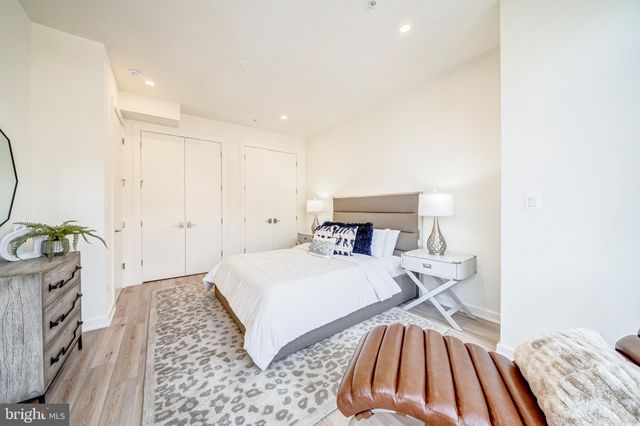 a bedroom with a bed and a mirror