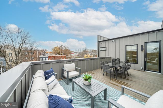 a balcony with furniture and a table