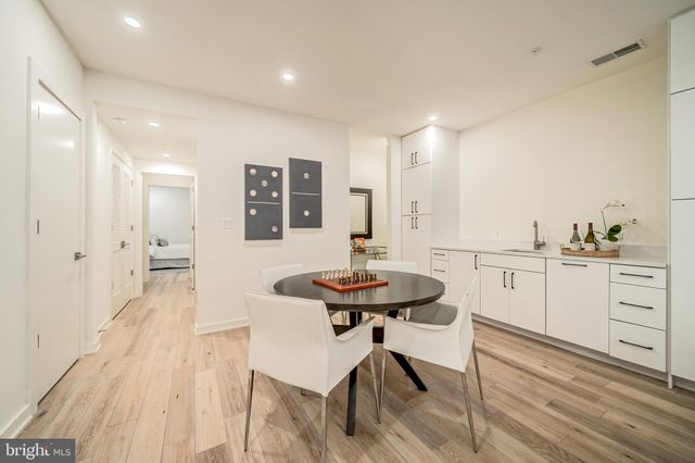 a view of a kitchen area with furniture and wooden floor
