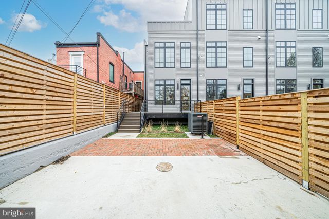 a view of a building with a door and a yard