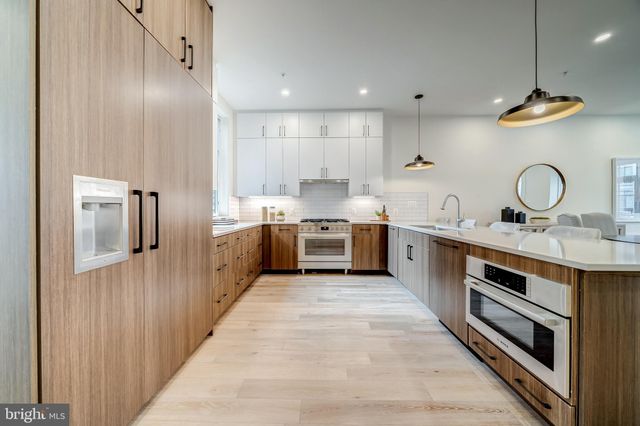 a kitchen with stainless steel appliances a sink and a stove