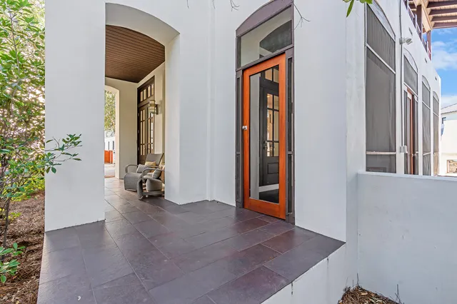 a living room with furniture a flat screen tv and a large window