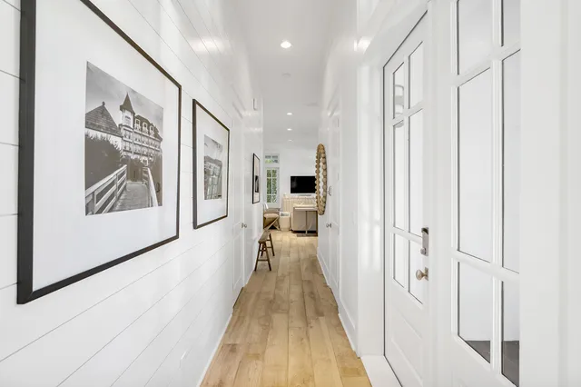 a large white kitchen with a large window and stainless steel appliances