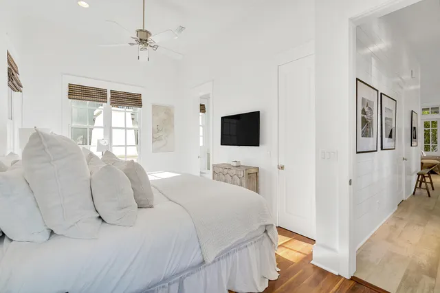 a large white kitchen with a large window and stainless steel appliances