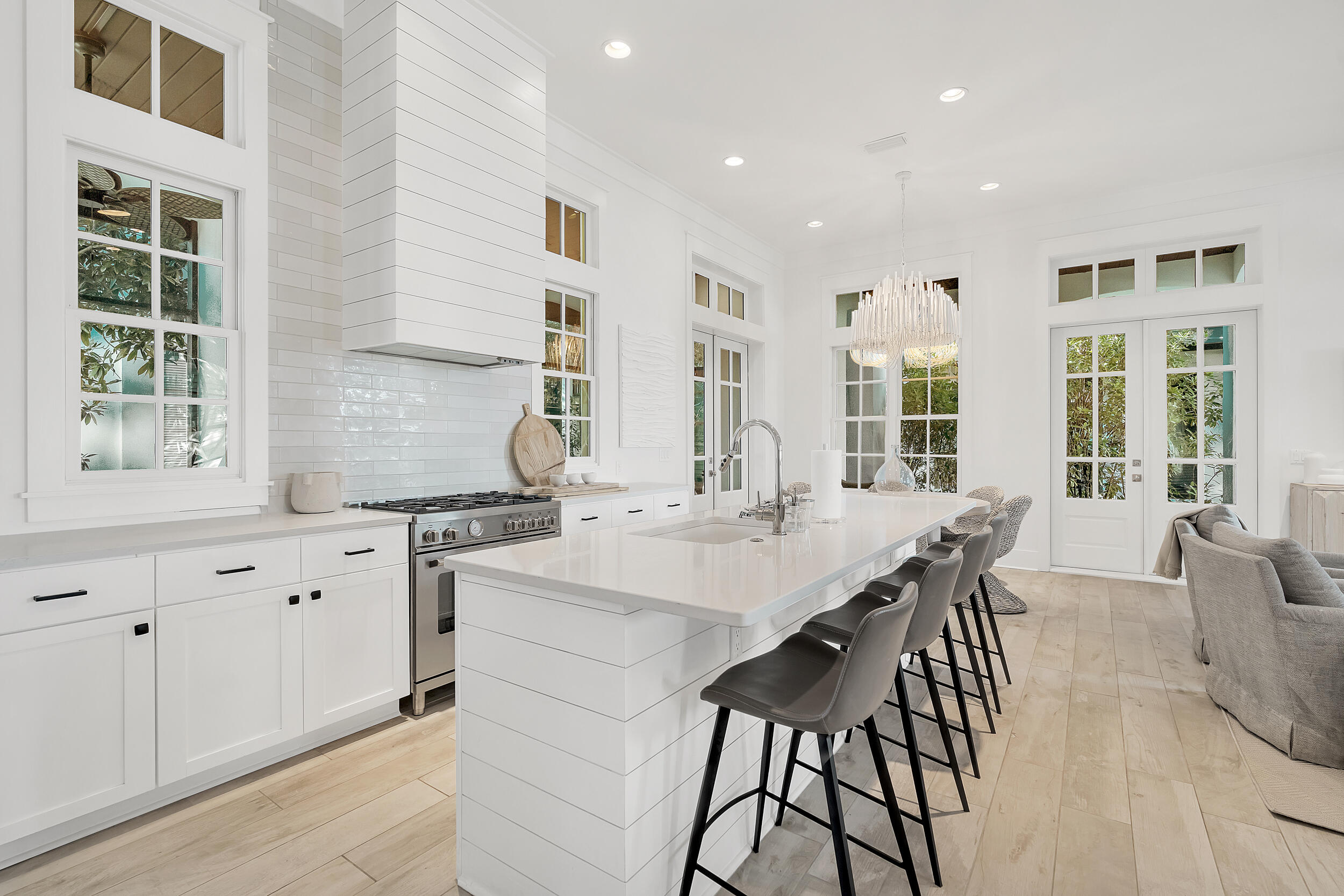 132 Kingston Road Rosemary Beach, FL 32461 - Photo 35 of 70 a kitchen with stainless steel appliances kitchen island granite countertop a stove a sink a refrigerator and white cabinets with wooden floor