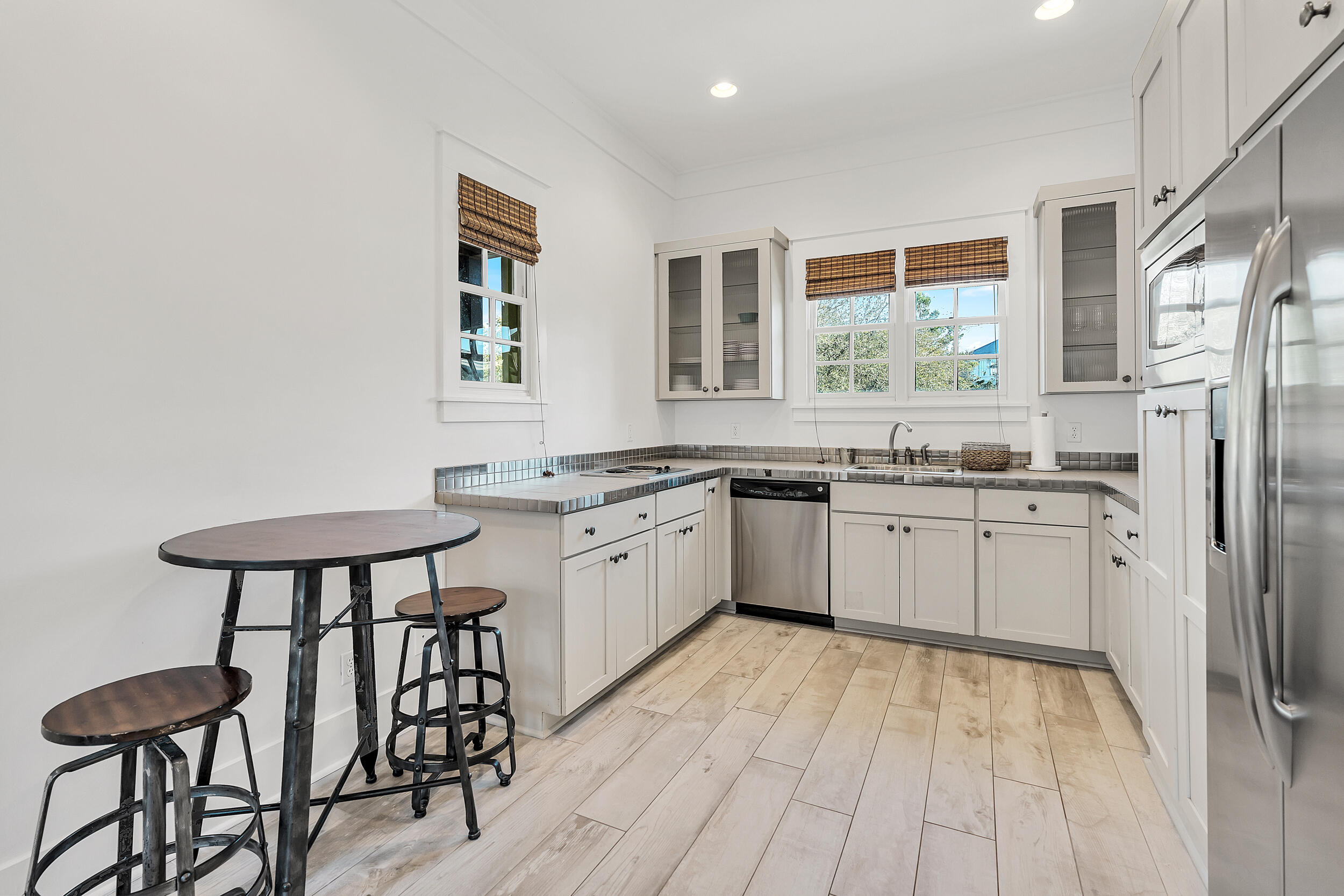 132 Kingston Road Rosemary Beach, FL 32461 - Photo 55 of 70 a kitchen with stainless steel appliances granite countertop a white cabinets and a refrigerator