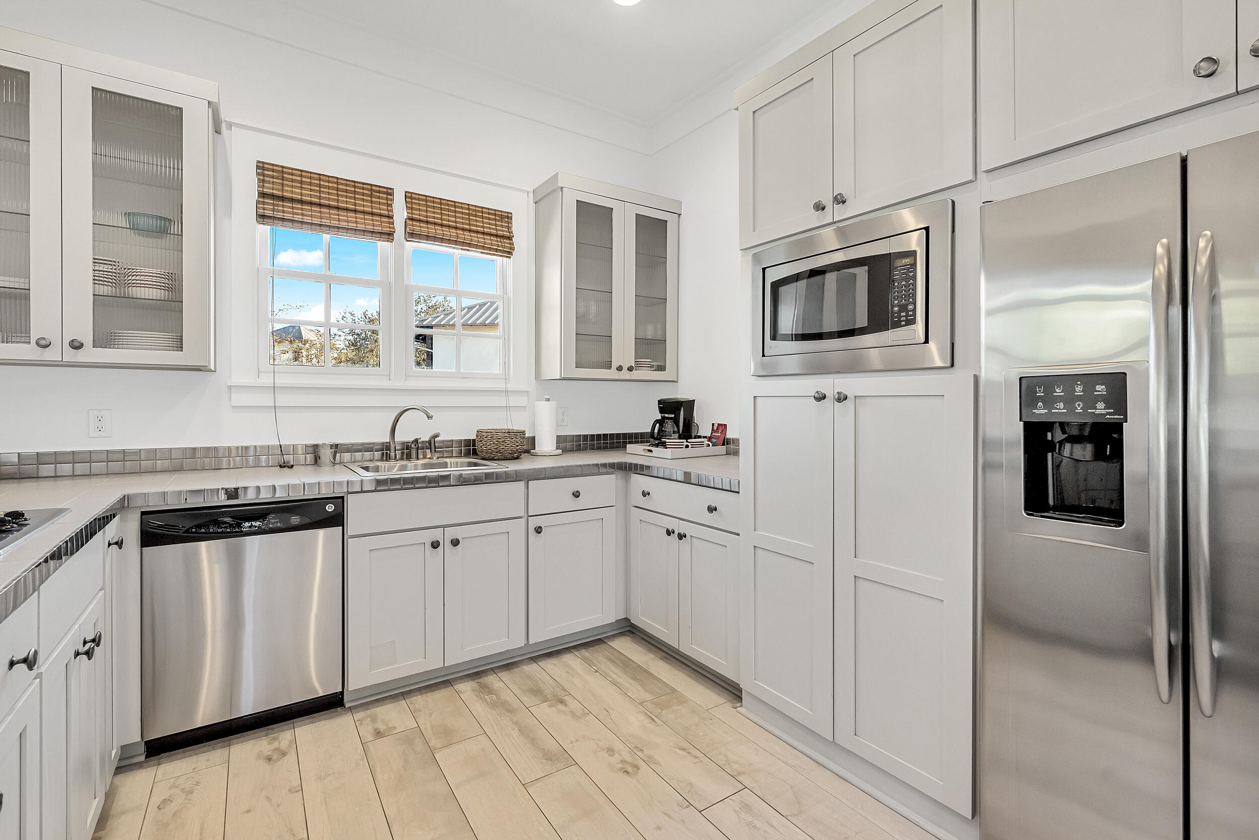 132 Kingston Road Rosemary Beach, FL 32461 - Photo 56 of 70 a kitchen with white cabinets a sink and a window