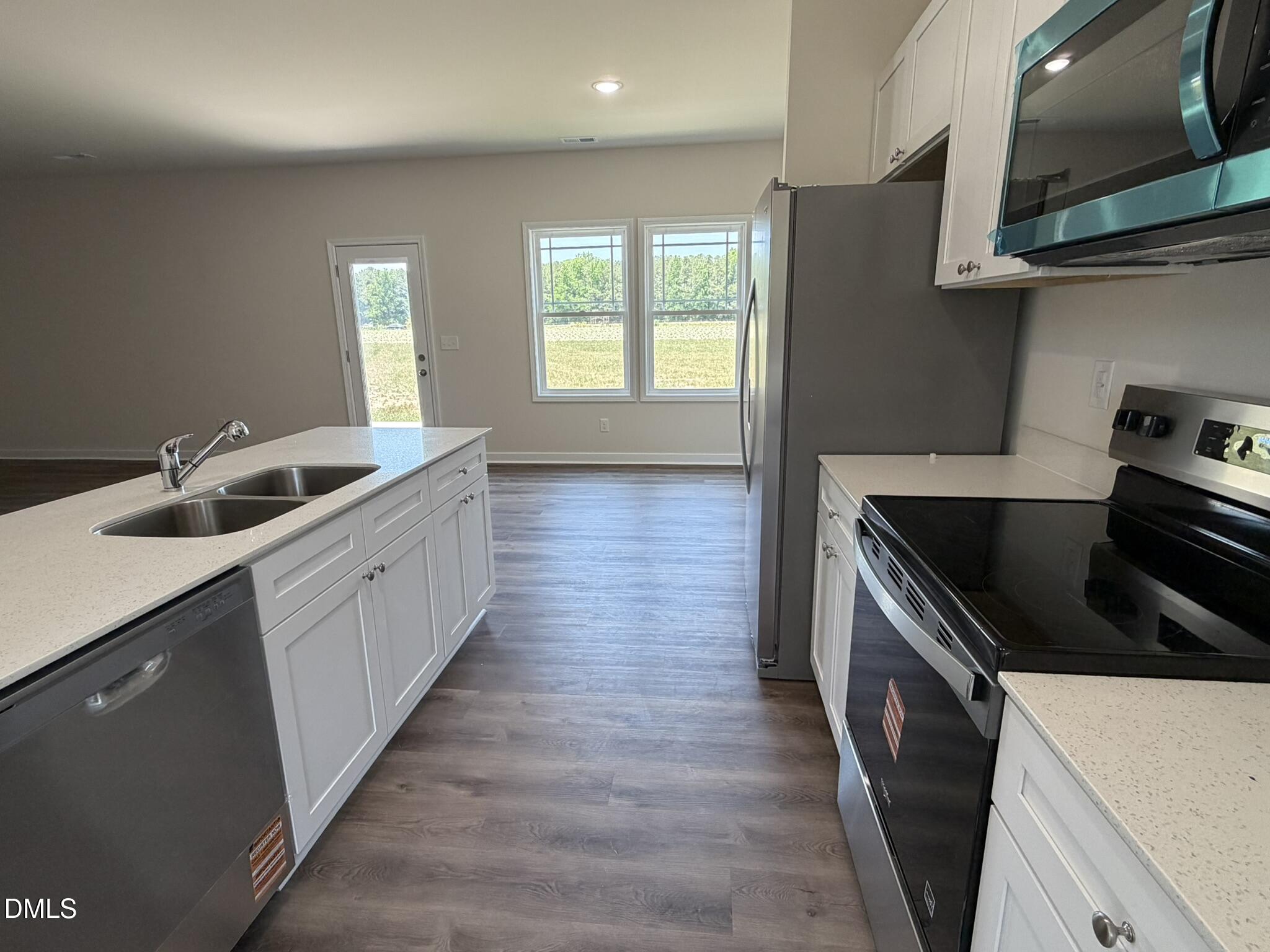 159 Jacobs Ridge Drive Four Oaks, NC 27524 - Photo 6 of 18 a kitchen with granite countertop a sink and stove top oven