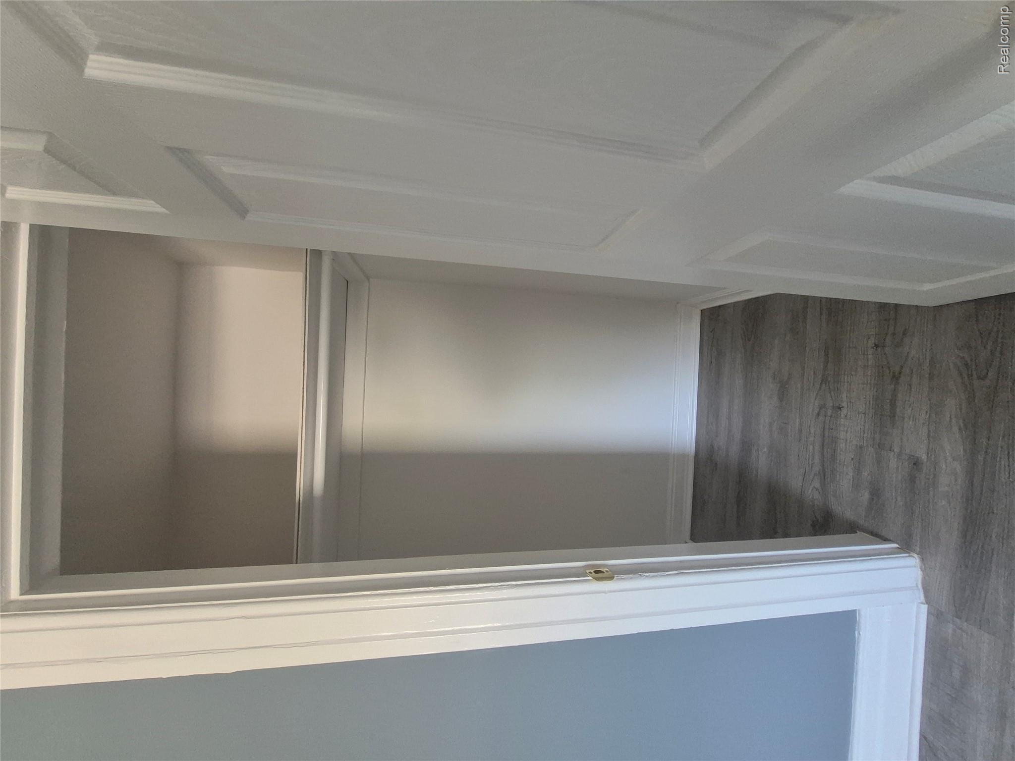 16758 Frazho Road Roseville, MI 48066 - Photo 38 of 53 Closet with wood-finish flooring, white trim, and a built-in hanging rod