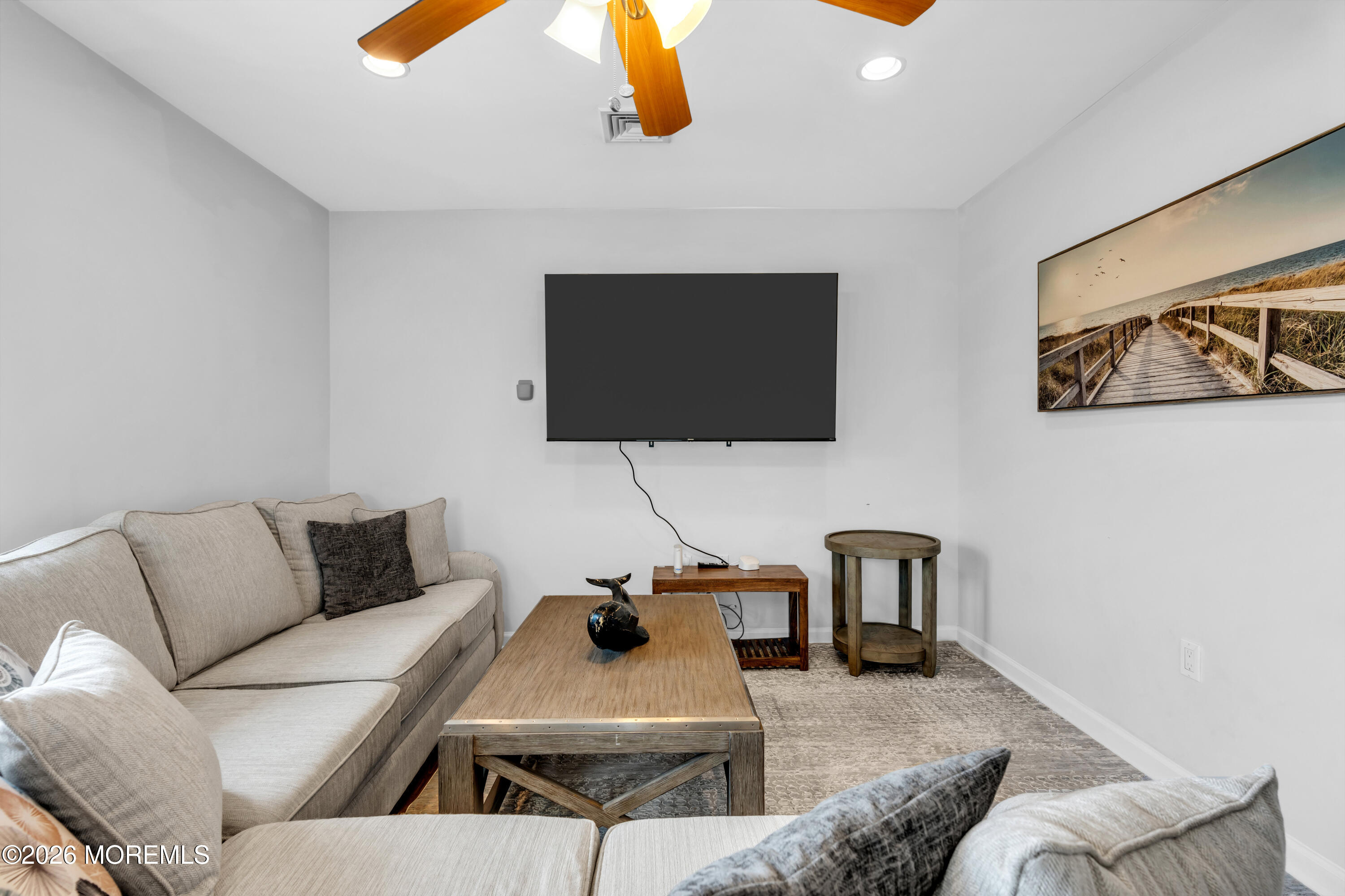 27 Arnold Avenue Point Pleasant Beach, NJ 08742 - Photo 11 of 48 a living room with furniture and a flat screen tv