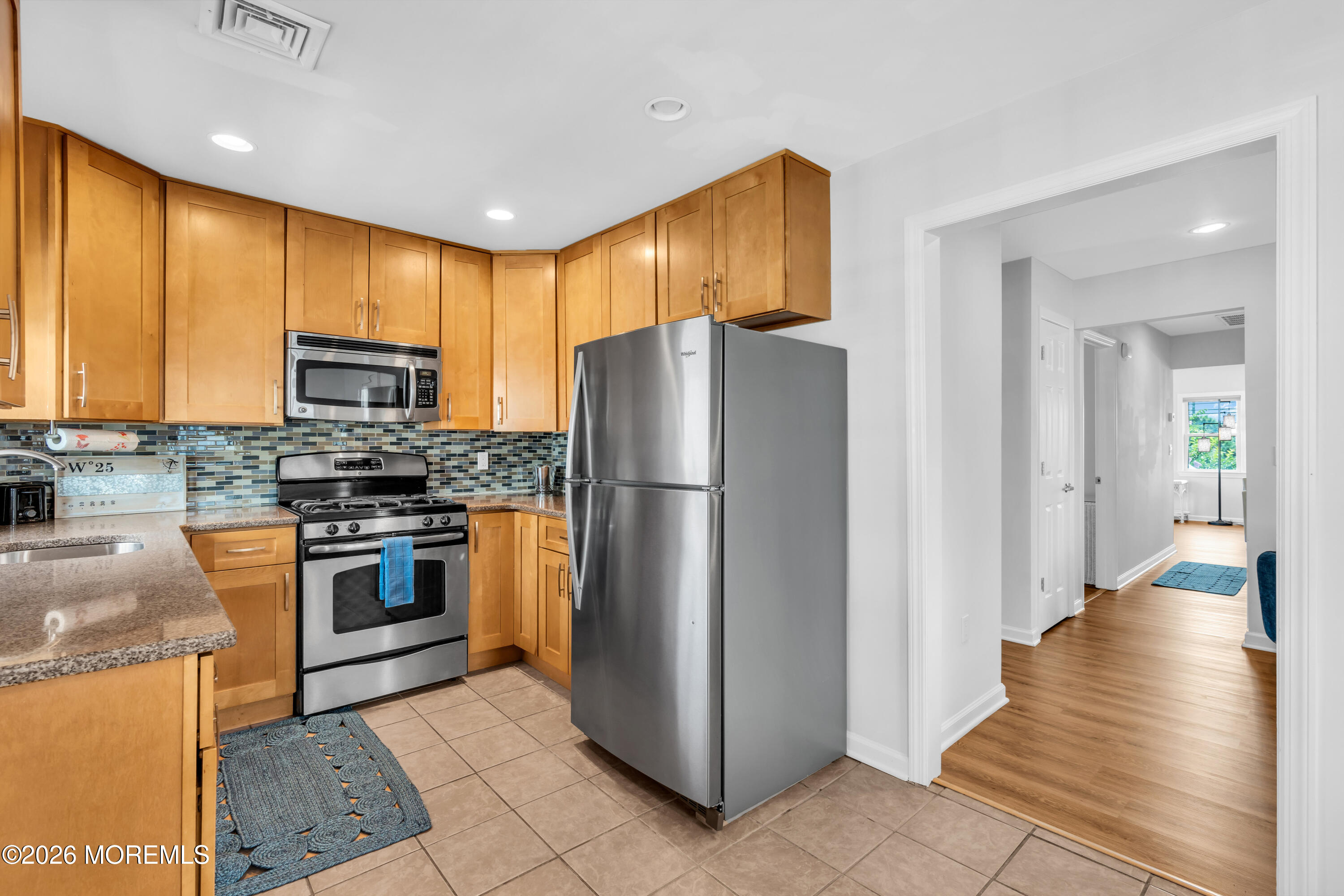 27 Arnold Avenue Point Pleasant Beach, NJ 08742 - Photo 23 of 48 a kitchen with granite countertop stainless steel appliances a refrigerator cabinets and a stove top oven