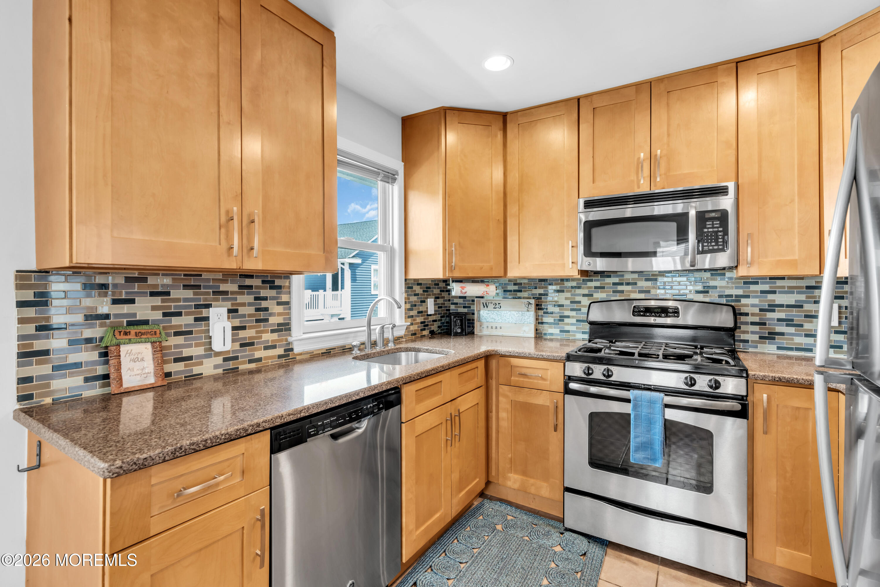 27 Arnold Avenue Point Pleasant Beach, NJ 08742 - Photo 24 of 48 a kitchen with stainless steel appliances granite countertop a stove a sink and a microwave