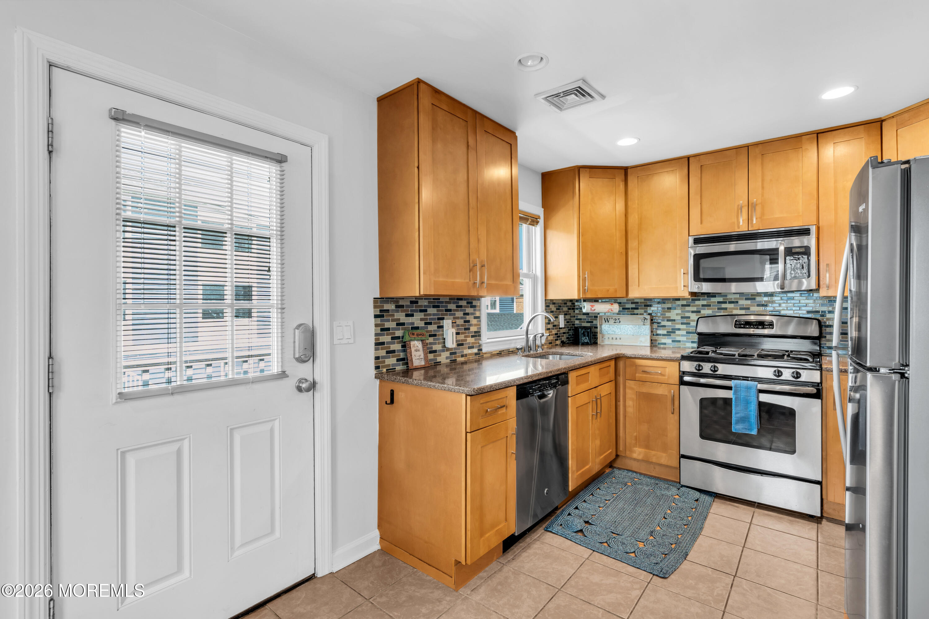 27 Arnold Avenue Point Pleasant Beach, NJ 08742 - Photo 26 of 48 a kitchen with stainless steel appliances granite countertop a stove a sink and a refrigerator