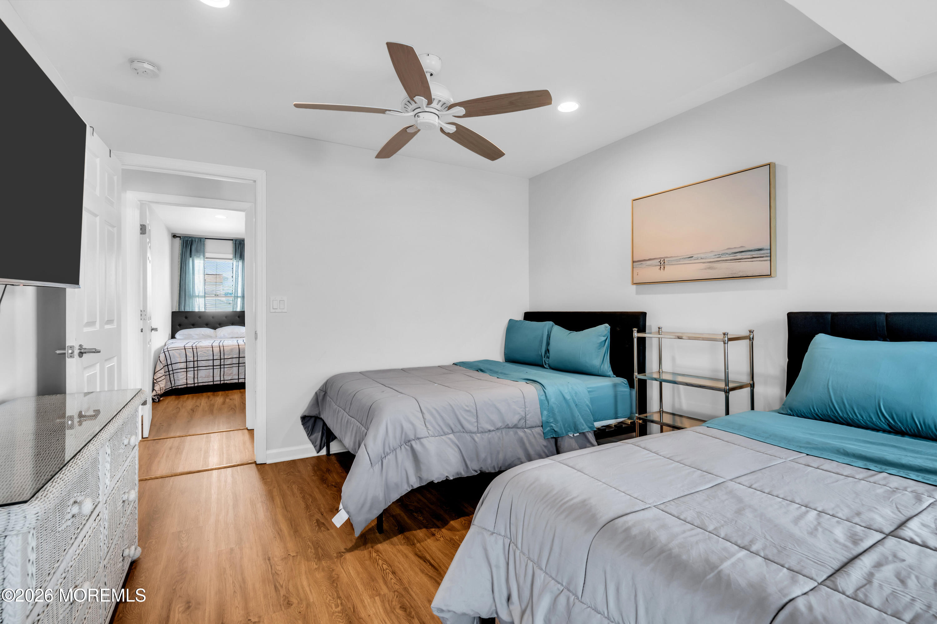 27 Arnold Avenue Point Pleasant Beach, NJ 08742 - Photo 30 of 48 a bedroom with two beds and a chandelier